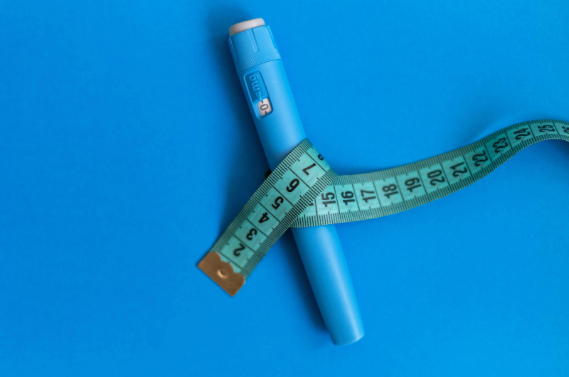 Non-Weight Loss Benefits of GLP-1 Weight Loss Medications such as Mounjaro or Ozempic 3 Tape measure and GLP1 injection pen.