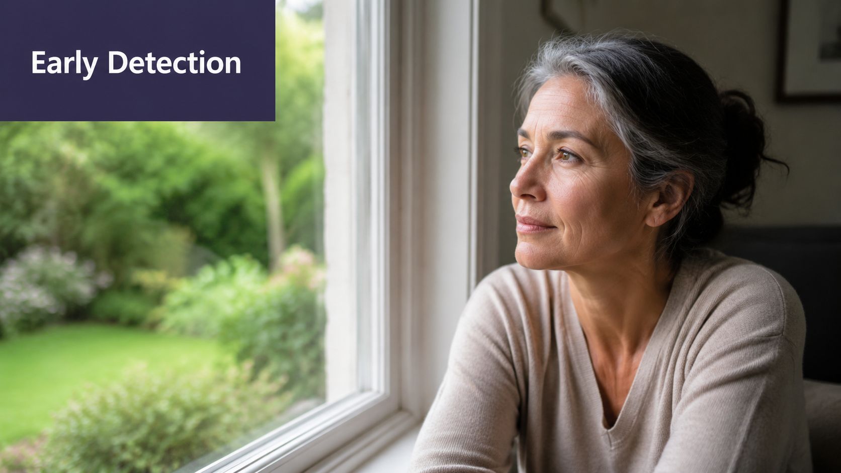 Find Bowel Cancer Screening Private in the UK for 2026 1 A middle-aged woman with grey hair looking thoughtfully out of a window toward a green garden.